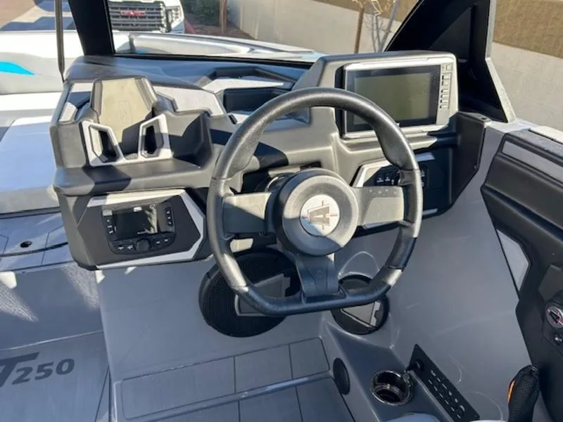 Slide: The Image of 2024 Axis T250 boat dashboard with steering wheel and control panel. - 11