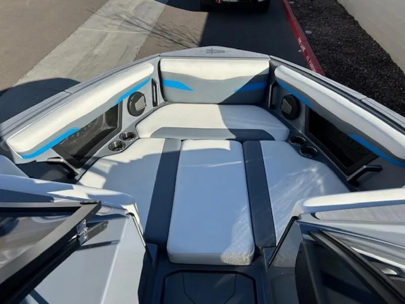 Slide: The Image of 2024 Axis T250 boat interior with gray and blue seating, cup holders, and sleek design. - 12