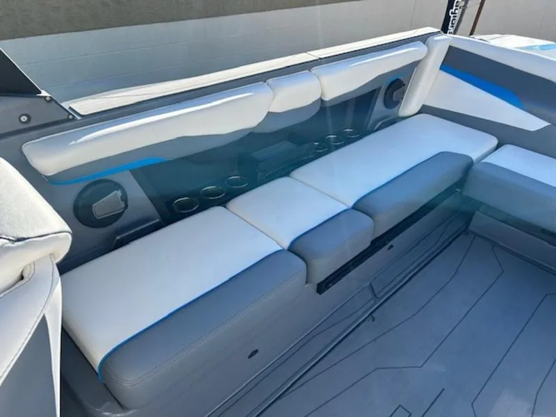 Slide: The Image of 2024 Axis T250 boat interior with gray and blue seating and cup holders. - 16