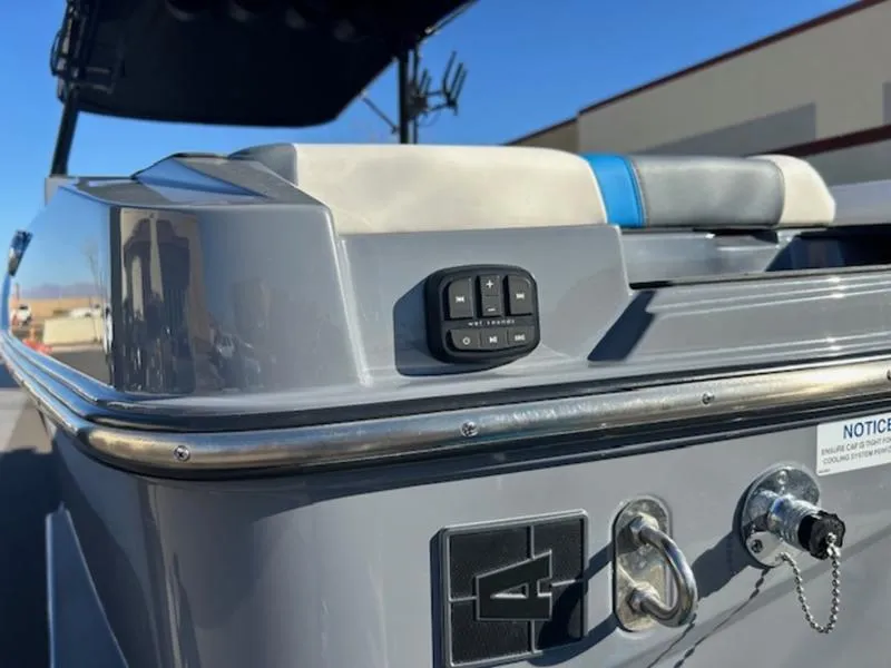 Slide: The Image of 2024 Axis T250 boat with control panel and seating, featuring sleek gray design. - 18