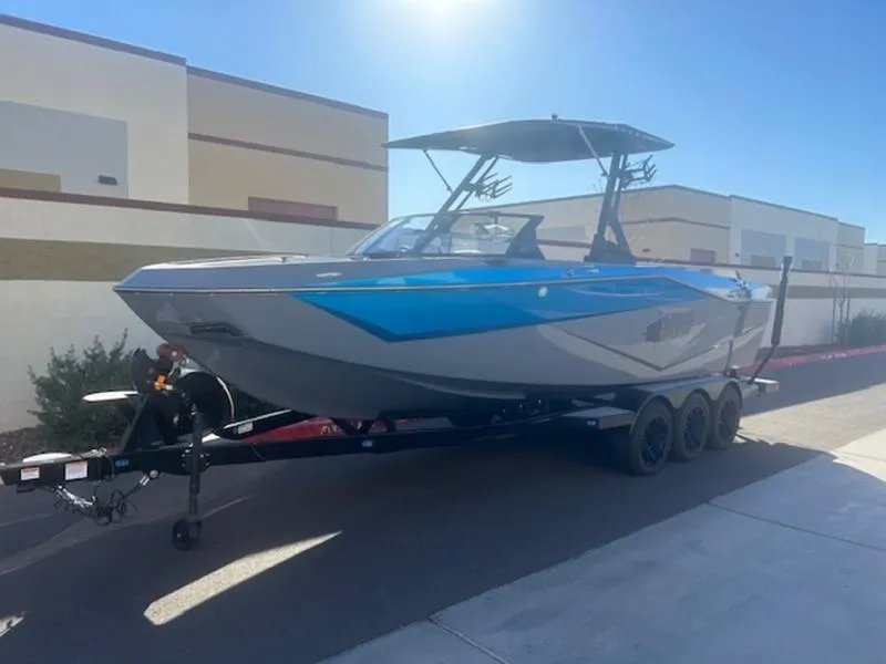 Slide: The Image of 2024 Axis T250 boat on trailer, parked outdoors under clear sky. - 3