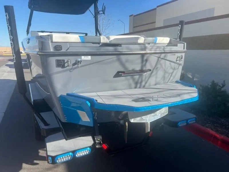 Slide: The Image of 2024 Axis T250 boat rear view with swim platform and blue accents. - 5