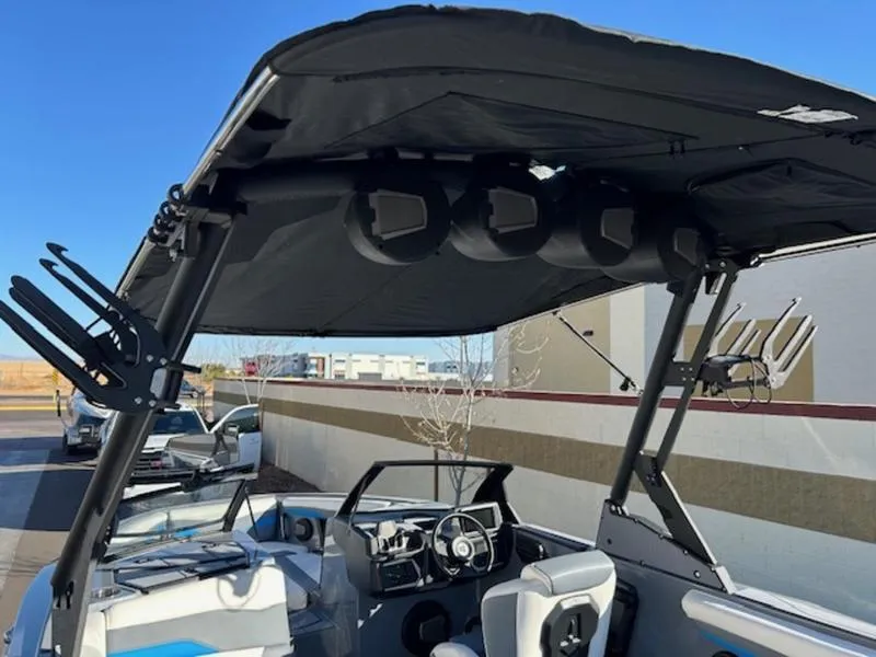 Slide: The Image of 2024 Axis T250 boat interior with black canopy and seating. - 8