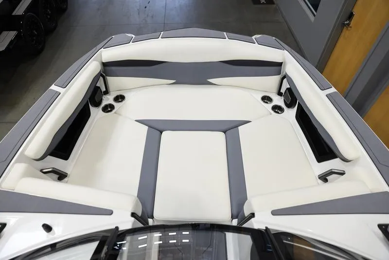 Slide: The Image of 2024 Axis A225 boat interior with white and gray seating, cup holders, and modern design. - 11