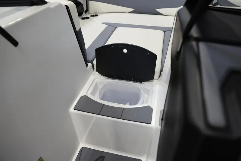 Slide: The Image of 2024 Axis A225 boat interior with storage compartment and seating area. - 13