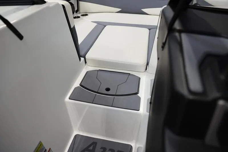 Slide: The Image of 2024 Axis A225 boat interior with gray and white seating and flooring. - 14
