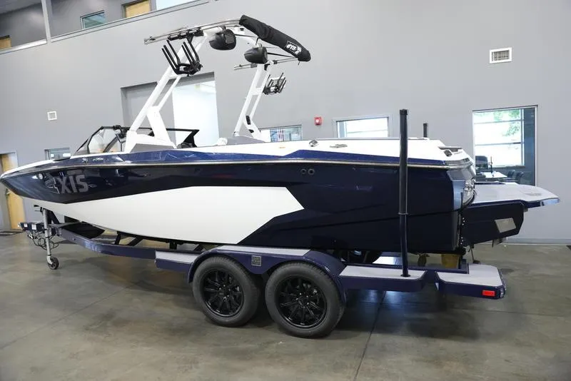 Slide: The Image of 2024 Axis A225 boat on trailer in showroom. - 22