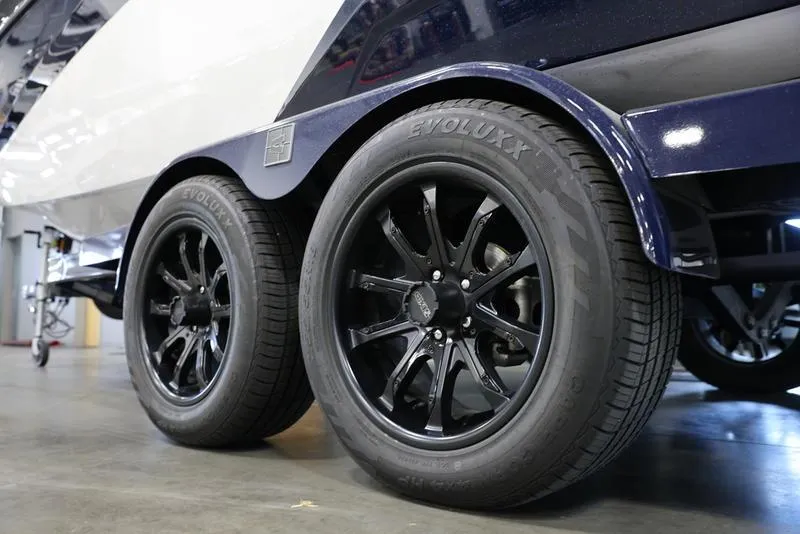 Slide: The Image of 2024 Axis A225 trailer with black Evoluxx tires and sleek rims. - 3