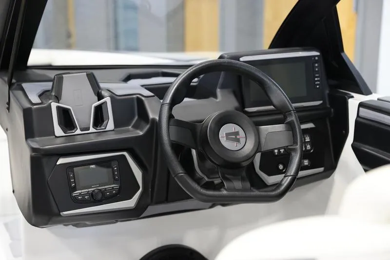 Slide: The Image of 2024 Axis A225 boat dashboard with steering wheel and digital displays. - 8
