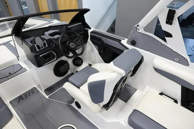 Slide: The Image of 2024 Axis A225 boat interior with modern dashboard and seating. - 9