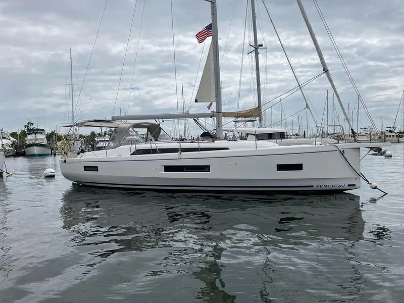 The Image of 2022 Beneteau Oceanis 40.1 sailboat docked in a marina, overcast sky. - 2
