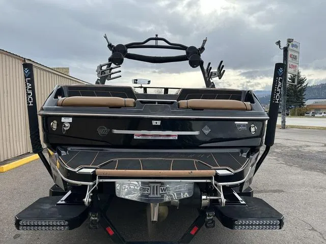 Slide: The Image of 2023 Malibu 23 LSV boat rear view, parked on a trailer. - 4