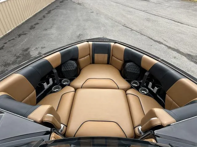 Slide: The Image of Luxurious interior of 2023 Malibu 23 LSV boat with tan and black seating. - 8