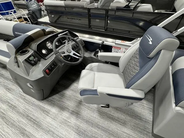 Slide: The Image of 2025 Bennington 23 SSR boat interior with steering console and captain's chair. - 11