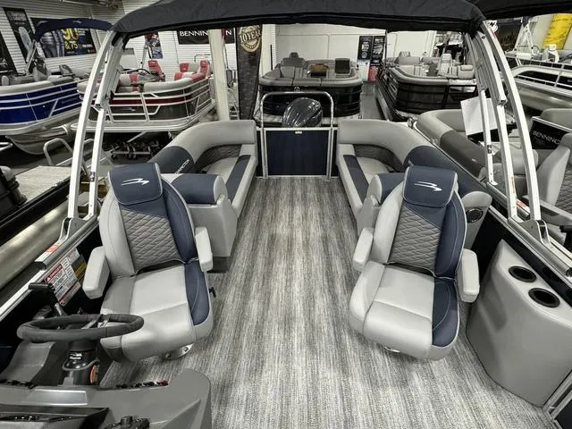 Slide: The Image of 2025 Bennington 23 SSR pontoon boat interior with plush seating and modern design. - 13