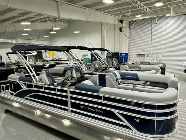 Slide: The Image of 2025 Bennington 23 SSR pontoon boats displayed in a showroom. - 22