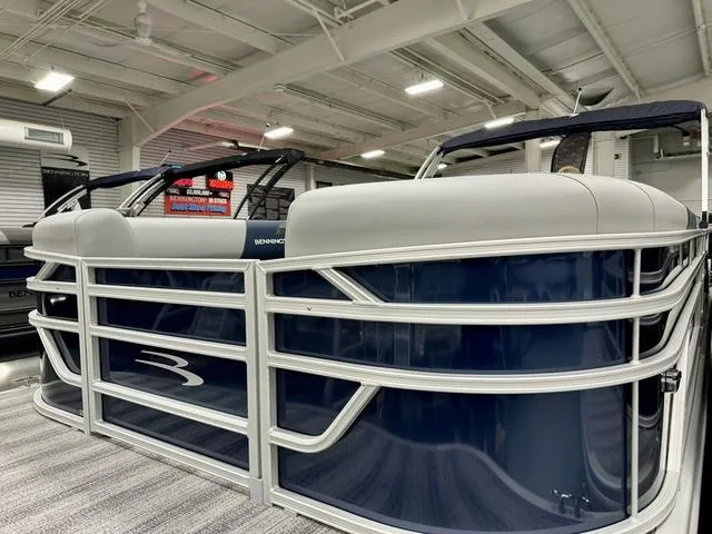 Slide: The Image of 2025 Bennington 23 SSR pontoon boat in showroom, featuring sleek design and modern amenities. - 23