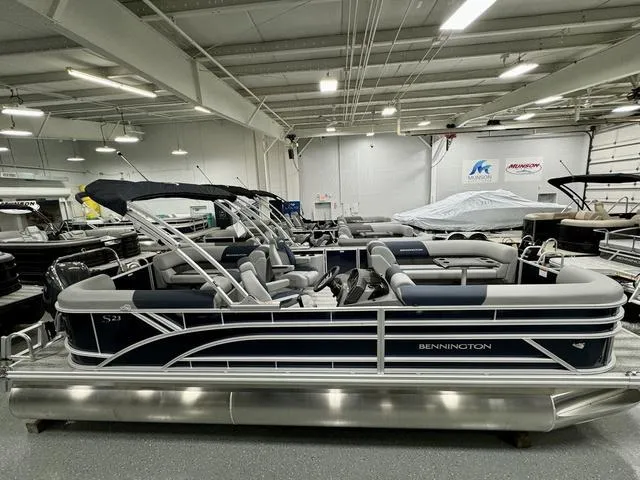 Slide: The Image of 2025 Bennington 23 SSR pontoon boat in showroom, featuring sleek design and modern seating. - 3