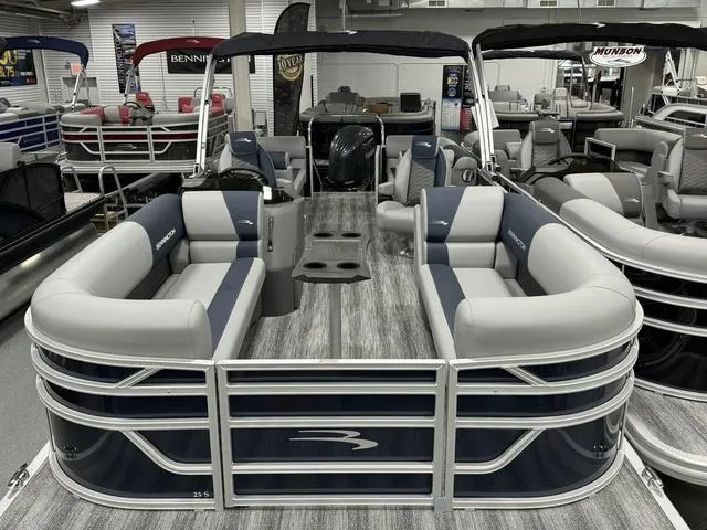 Slide: The Image of 2025 Bennington 23 SSR pontoon boat with spacious seating and modern design in showroom. - 5