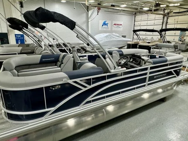 Slide: The Image of 2025 Bennington 23 SSR pontoon boat in showroom, featuring sleek design and modern seating. - 6