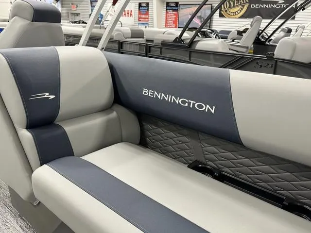 Slide: The Image of 2025 Bennington 23 SSR boat interior with gray and blue seating, showroom display. - 9