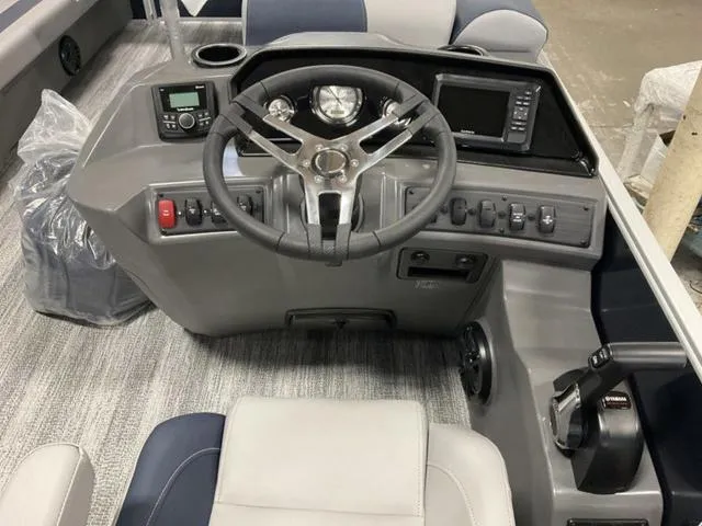 Slide: The Image of 2025 Bennington 23 SSB boat dashboard with steering wheel and control panel. - 4