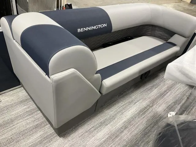 Slide: The Image of 2025 Bennington 23 SSB boat seating, featuring sleek gray and navy upholstery. - 7