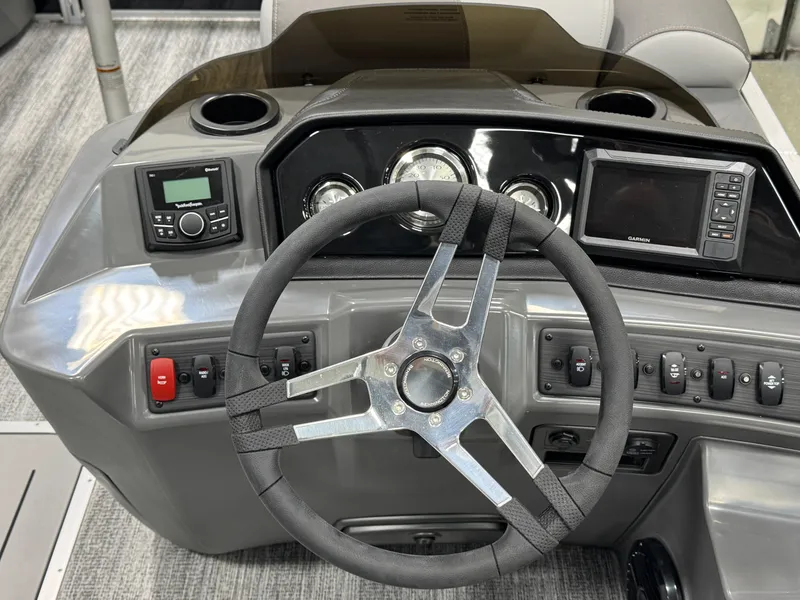 Slide: The Image of 2025 Bennington 22 SSR boat dashboard with steering wheel, gauges, and control panel. - 10
