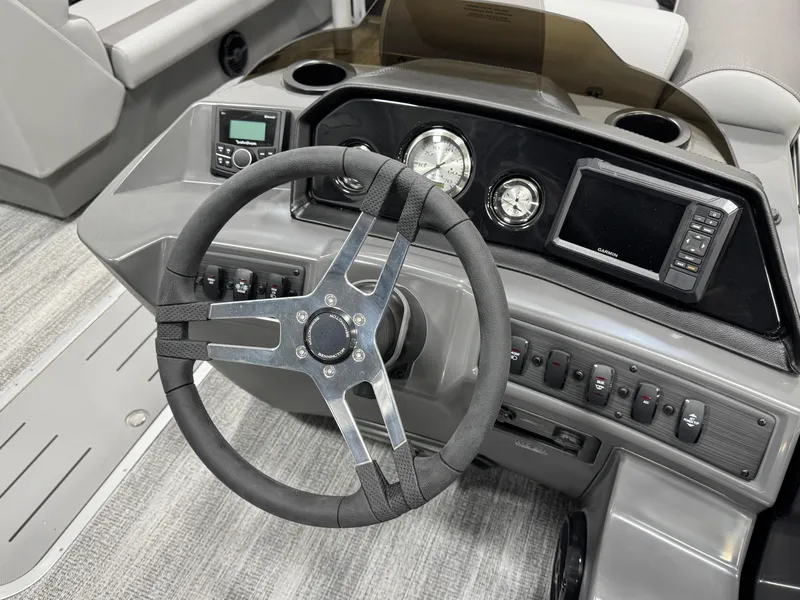 Slide: The Image of 2025 Bennington 22 SSR boat dashboard with steering wheel, gauges, and control panel. - 12