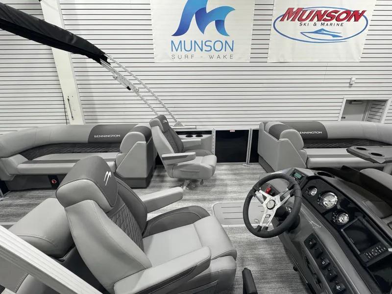Slide: The Image of 2025 Bennington 22 SSR boat interior with gray seating and steering console. - 13