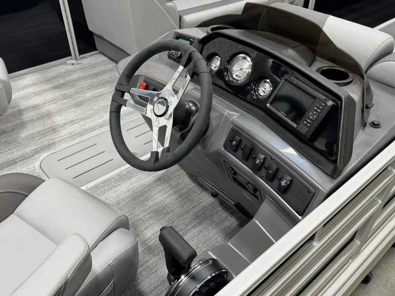 Slide: The Image of 2025 Bennington 22 SSR boat dashboard with modern controls and steering wheel. - 16