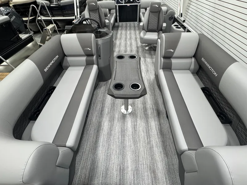 Slide: The Image of 2025 Bennington 22 SSR pontoon boat interior with gray seating and central table. - 17
