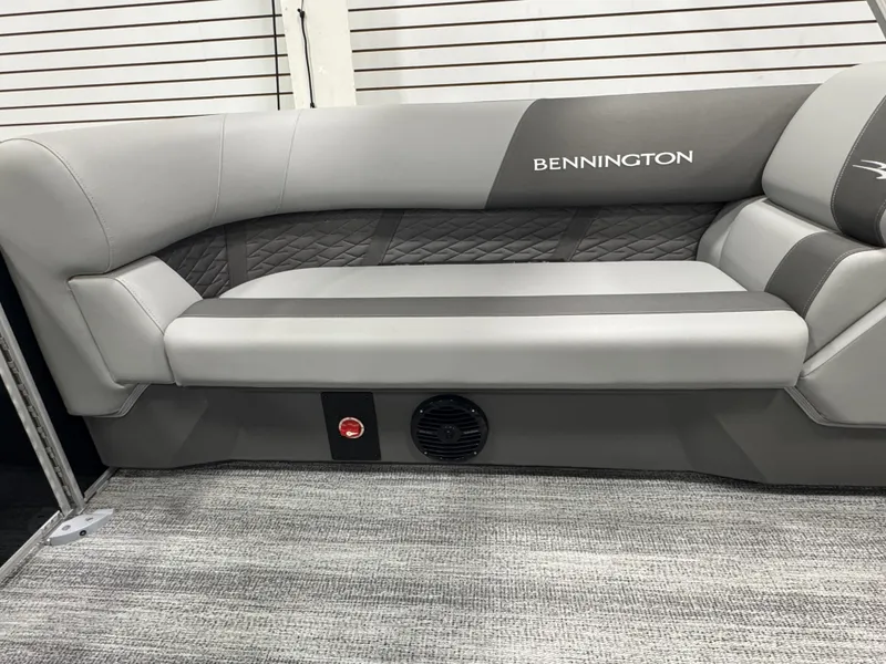 Slide: The Image of 2025 Bennington 22 SSR boat interior with gray seating and quilted accents. - 20