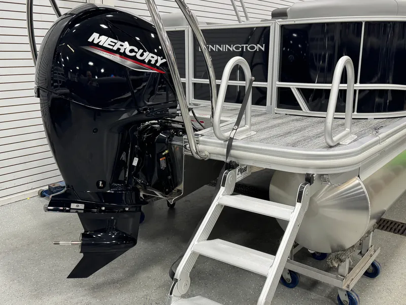 Slide: The Image of 2025 Bennington 22 SSR pontoon boat with Mercury outboard motor and boarding ladder. - 21