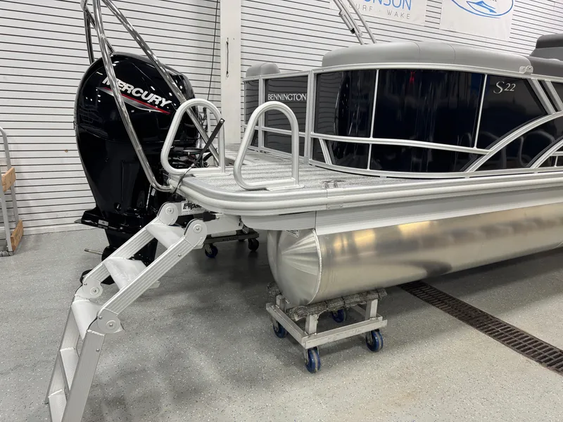 Slide: The Image of 2025 Bennington 22 SSR pontoon boat with Mercury engine in showroom. - 22