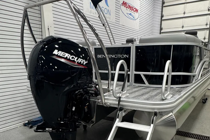 Slide: The Image of 2025 Bennington 22 SSR pontoon boat with Mercury outboard motor in showroom. - 23
