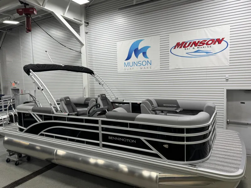Slide: The Image of 2025 Bennington 22 SSR pontoon boat in showroom, featuring sleek design and comfortable seating. - 3