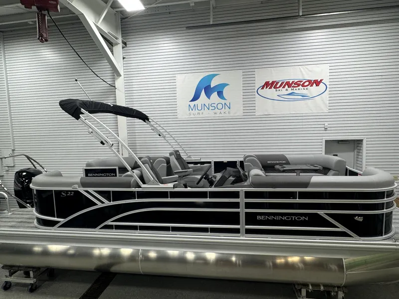 Slide: The Image of 2025 Bennington 22 SSR pontoon boat in showroom with Munson signage. - 4