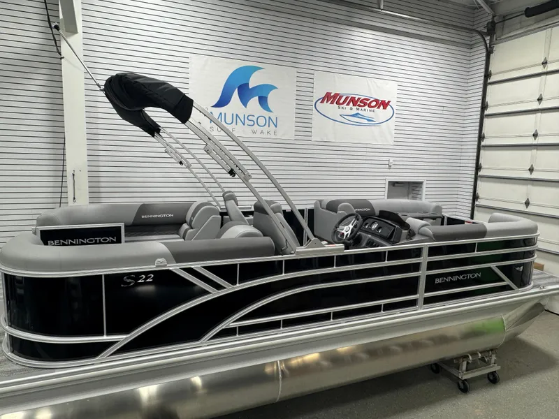 Slide: The Image of 2025 Bennington 22 SSR pontoon boat in showroom with Munson Marine signage. - 5