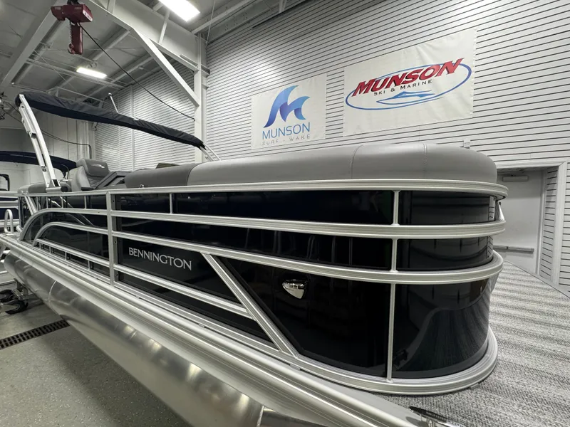 Slide: The Image of 2025 Bennington 22 SSR pontoon boat in showroom, sleek design, Munson Marine signage. - 8