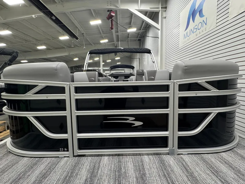 Slide: The Image of 2025 Bennington 22 SSR pontoon boat displayed indoors at Munson Lakes. - 9