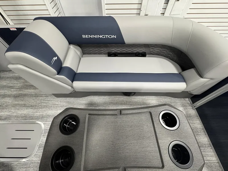 Slide: The Image of 2025 Bennington 22 SSB boat interior with gray and blue seating and cup holders. - 11