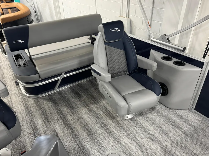 Slide: The Image of 2025 Bennington 22 SSB boat interior with gray seating and cup holders. - 13