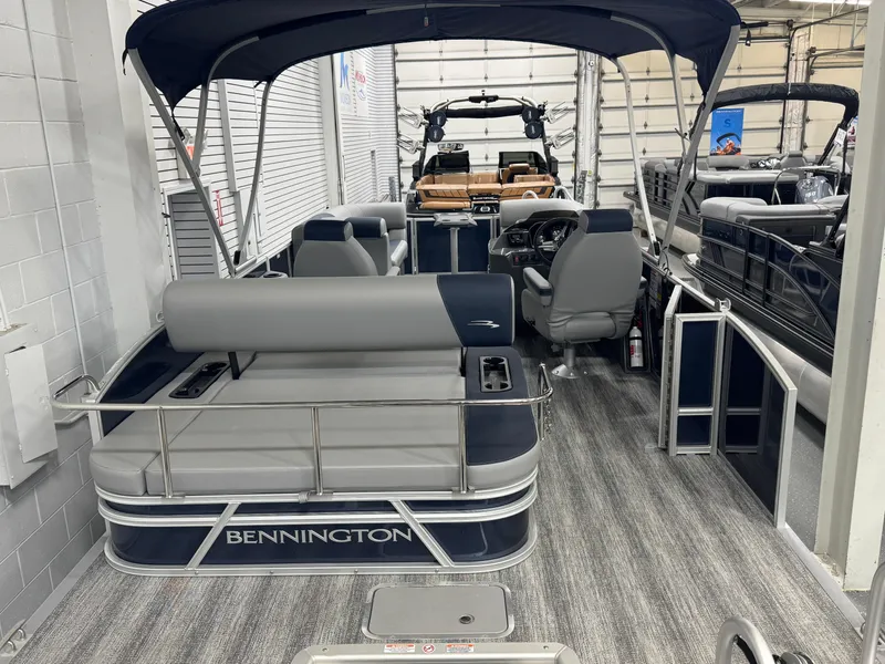 Slide: The Image of 2025 Bennington 22 SSB pontoon boat with spacious seating and modern design in showroom. - 14