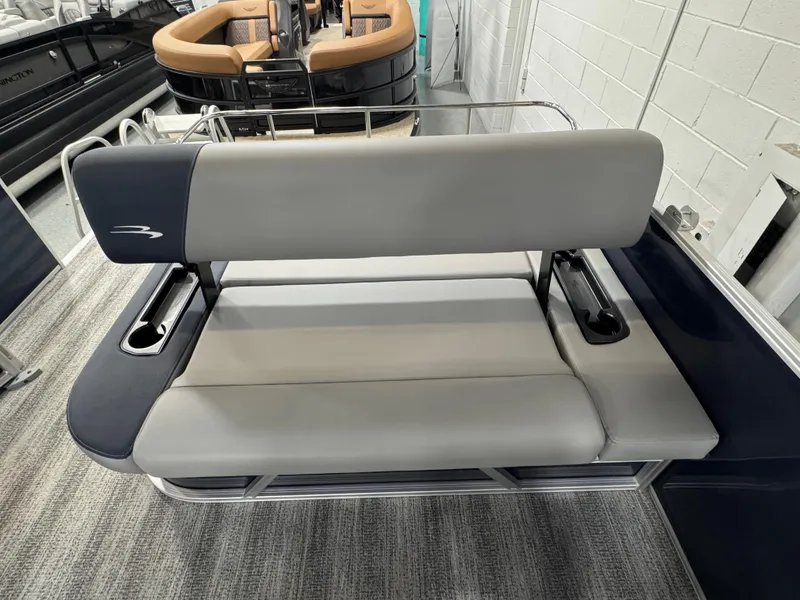 Slide: The Image of 2025 Bennington 22 SSB boat seat with gray upholstery and cup holders. - 17