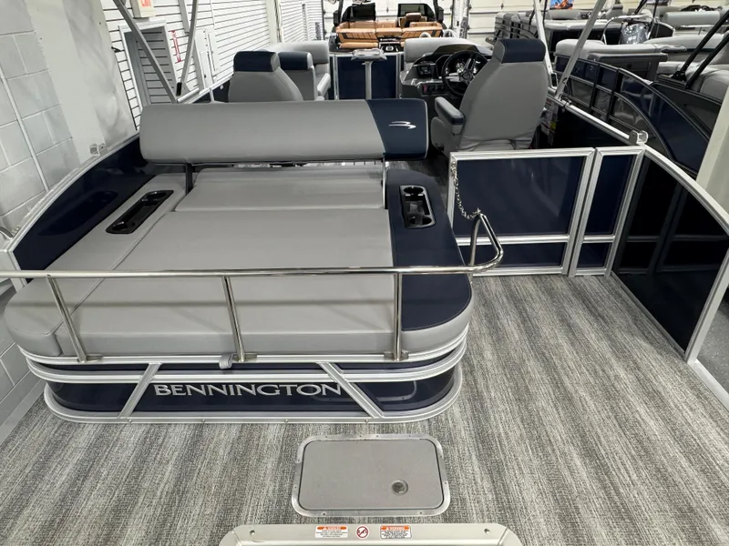 Slide: The Image of 2025 Bennington 22 SSB pontoon boat interior with seating and helm, showcasing modern design. - 18