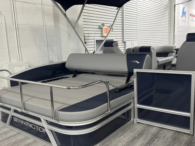 Slide: The Image of 2025 Bennington 22 SSB pontoon boat with sleek seating and modern design in showroom. - 19