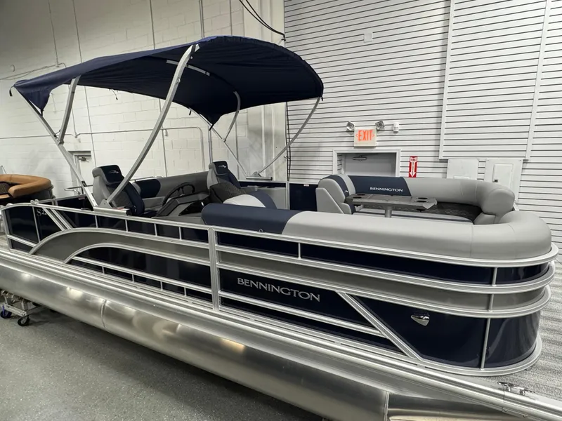 Slide: The Image of 2025 Bennington 22 SSB pontoon boat with canopy in showroom setting. - 3