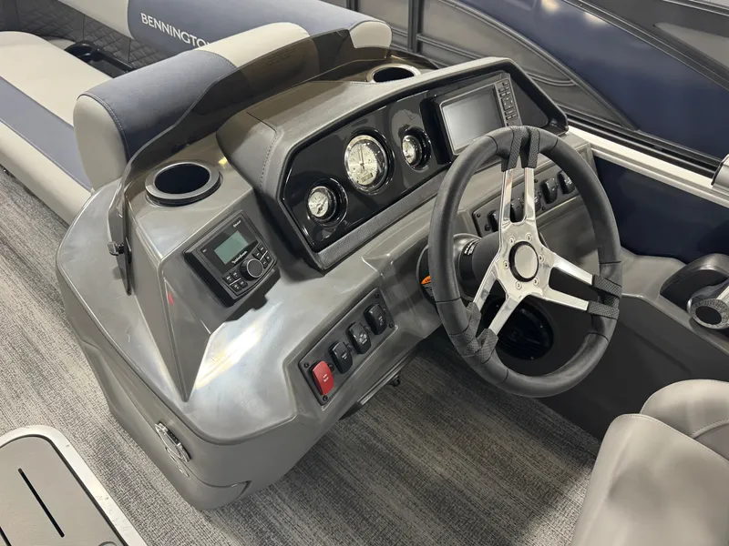 Slide: The Image of 2025 Bennington 22 SSB boat dashboard with steering wheel and control panel. - 7