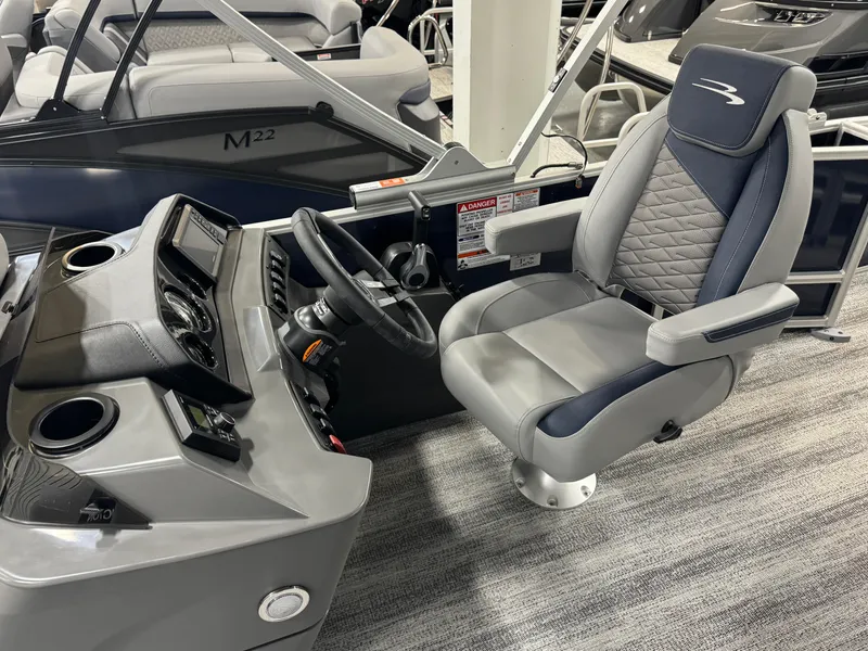Slide: The Image of 2025 Bennington 22 SSB boat interior with steering wheel and captain's chair. - 8